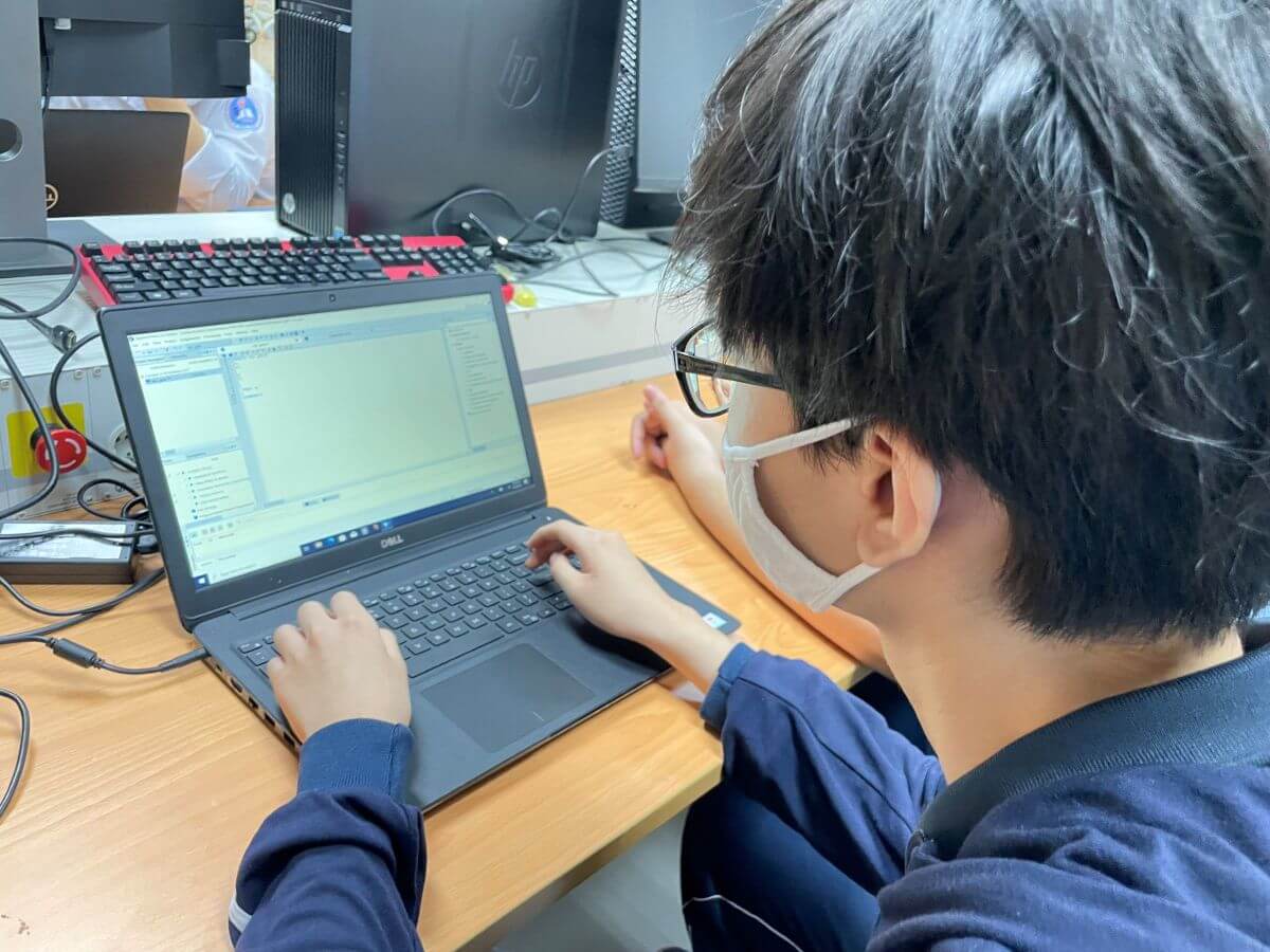 High school student experiences writing code lines in Chip design
